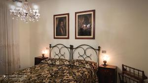 a bedroom with a bed and two pictures on the wall at Dolce Sosta Casa Vacanza in Comacchio