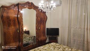 a bedroom with a large mirror and a tv at Dolce Sosta Casa Vacanza in Comacchio