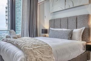 a bedroom with a large white bed and a window at Bella Vista at Ellipse in Midrand