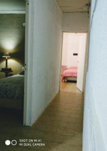 un corridoio che conduce a una camera da letto con un letto di Departamento Monte Caseros a Monte Caseros