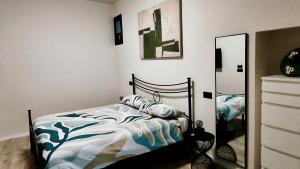a bedroom with a bed and a mirror at La Morra Apartments in La Morra +5 photos