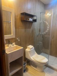 a bathroom with a toilet and a glass shower at Casa calendario azteca in Playa del Carmen +58 photos