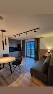 a living room with a couch and a table at Reiterhof in Westendorf