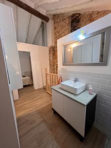 a bathroom with a sink and a mirror at Restored house near Valencia in Simat de Valldigna