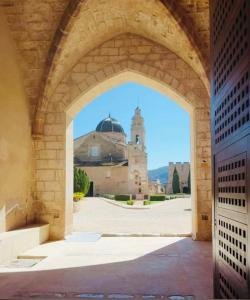 an archway leading to a building with a mosque at Restored house near Valencia in Simat de Valldigna