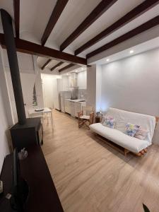 a living room with a couch and a kitchen at Restored house near Valencia in Simat de Valldigna