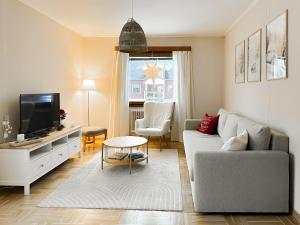 a living room with a couch and a tv at Aurora House in Karungi