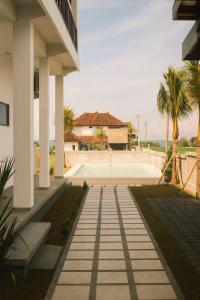 a house with a view of a courtyard at MADEWITH hostel in Airsatang