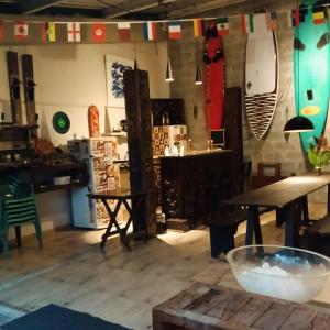 una habitación con mesas y tablas de surf en la pared en Green Lodge Eco Life Hotel, en Florianópolis