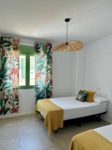 a bedroom with a bed and two windows at OCEAN APARTAMENT !! 1ª Línea del Mar, piscina, parking, wifi in Mojácar