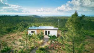 an aerial view of a small house in a field at Hidden Valley Wilderness Lodge in San Ignacio