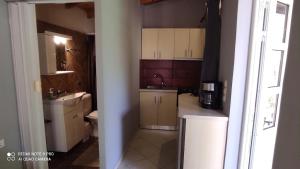 a small kitchen with a sink and a toilet at Lea's Apartment in Kourouta +56 photos