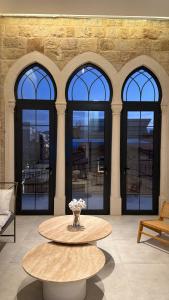 a large room with a table and four windows at EYZ Lofts By EYZ Holiday Homes in Batroûn