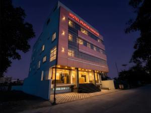 a building with a lit up facade at night at Hotel Pragya Paradise in Indore