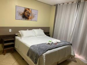 a bedroom with a bed with a lion picture on the wall at Apto 013 - Residencial Canaã in Porto Velho