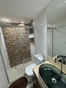 a bathroom with a sink and a toilet and a shower at Ap inteiro St Bueno 2 quartos in Goiânia +13 photos