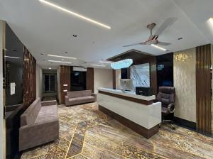 a lobby of a hotel with a reception desk at Hotel Pragya Paradise in Indore