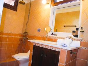a bathroom with a sink and a toilet and a mirror at Lea's Ηοme in Kourouta +74 photos