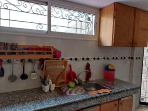 a kitchen counter with a sink and a window at Dream House Sidi Rahal Beach in Sidi Rahal +9 photos
