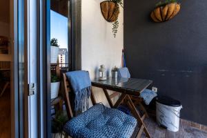 a table and chairs in a room with a window at Avantura apartman 14 in Zlatibor