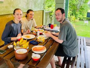 a group of people sitting at a table eating food at Aura Villa in Polonnaruwa
