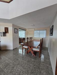 ein Esszimmer mit einem Holztisch und Stühlen in der Unterkunft Residencial Alter do Chao - Apartamento Duplex in Santarém