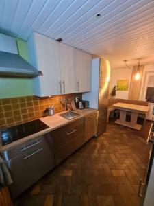 a kitchen with a sink and a counter top at Gästehaus Mohr in Eberhardzell