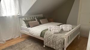 a white bed with pillows on it in a bedroom at Anyas rooms Ltd in Antrim