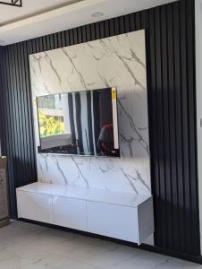 En eller flere senge i et værelse på Kumwitu Kingsland