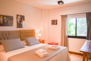 a bedroom with a bed with two towels on it at Hotel San Germán de Muñiz in Muñiz