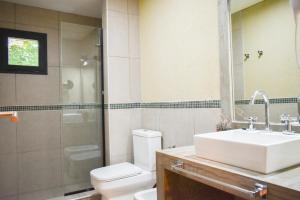 a bathroom with a sink and a toilet and a shower at Hotel San Germán de Muñiz in Muñiz