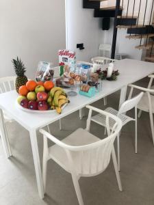 a white table with a plate of fruit on it at The White House Toledo in Toledo