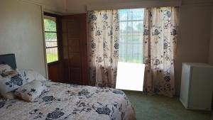 En eller flere senge i et værelse på SashMc Flair Guesthouse