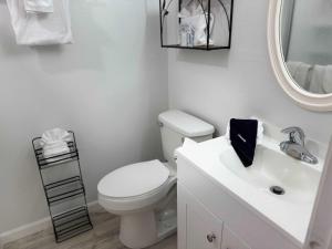 a bathroom with a white toilet and a sink at Tropical Isle 209 w Convenient Beach Access in Fort Walton Beach