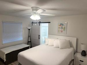 a bedroom with a bed and a ceiling fan at Tropical Isle 209 w Convenient Beach Access in Fort Walton Beach