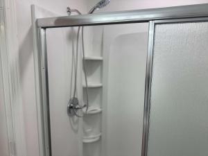 a shower stall with a glass door with a shower at Tropical Isle 209 w Convenient Beach Access in Fort Walton Beach
