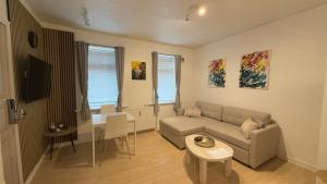 a living room with a couch and a table at Apartment in the heart of Esbjerg Center in Esbjerg