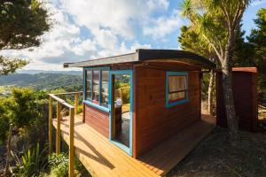 a tiny house on a deck with a view at Ocean Purring Views in Tutukaka