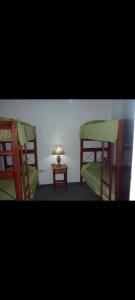 two bunk beds in a room with a table at Kilometro Cero in La Quiaca