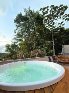 a bath tub sitting on top of a deck at Chales da Trilha in Penha