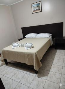 Una cama o camas en una habitación de Hostal Bless Tacna