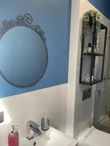 a bathroom with a sink and a mirror on the wall at Warszawska in Toruń