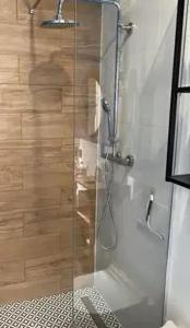 a shower with a glass door in a bathroom at Warszawska in Toruń