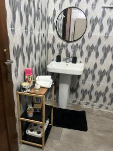 a bathroom with a sink and a mirror at Serenity by Feliho House in Dakar