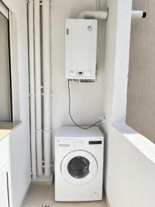 a washer and dryer in a corner of a room at Palmier d'or in Tunis