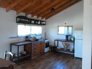 a kitchen with a sink and a refrigerator at Runa, Marcos de los Reyes villa serrana in Minas
