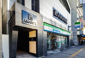a store front of a building on a city street at HOTEL AMANEK Osaka Namba in Osaka