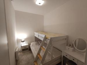 a small bedroom with a bunk bed and a mirror at Hena, Free Parking Included in Bjelašnica
