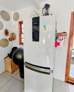 a white refrigerator freezer in a kitchen with at Casa de Adobe in Lençóis