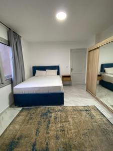 a bedroom with a bed and a window and a rug at Central Park hotel apartment in Madinaty